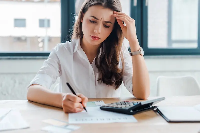 Am I In Too Much Debt? 10 Warning Signs & What To Do Next